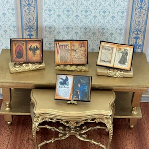 Könnte beinhalten: Eine weiße Keramik-Tasse mit schwarzem Henkel und dem Text "But First, Coffee" in fetter, schwarzer Schrift. Die Tasse steht vor einem verschwommenen Hintergrund, der eine gemütliche Umgebung andeutet.