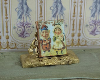 Miniature illustrated book punch and judy book child. 1:12 Miniature books & toys for dollhouse collectors. Dollhouse openable bookchild.