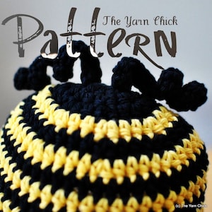 May include: Crochet pattern for a bee-themed hat with black and yellow stripes. The pattern is titled "The Yarn Chick Pattern".