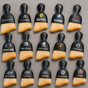 May include: A collection of fifteen black detailing brushes with rounded handles, each featuring a unique automotive brand logo including Mercedes-Benz, Citroen, Ferrari, BMW, Audi, Mazda, Alfa Romeo, Peugeot, Lamborghini, Volvo, Hyundai, Toyota, Ford, Volkswagen, and Fiat.