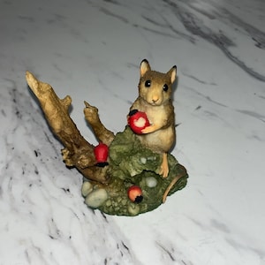 house mouse perched on a faux tree stump, holding a red berry by Coalport