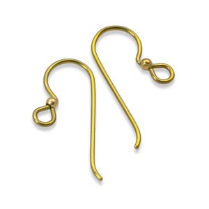May include: Two gold-colored earring hooks are displayed against a white background. Each hook has a curved top with a small ball and a loop, and a long, slender, curved bottom. The hooks are designed for jewelry making.