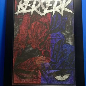 May include: A framed print of a black and white illustration of a character from the Berserk manga series. The character is wearing a large, horned helmet and armor. The title "BERSERK" is written in silver lettering at the top of the print.