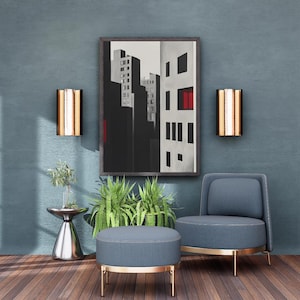 Puede incluir: Una escena de salón moderno con una obra de arte enmarcada de un paisaje urbano, un sillón azul y una otomana a juego. Dos apliques de pared con detalles dorados y blancos flanquean la obra de arte. Una pequeña mesa auxiliar plateada con una planta.