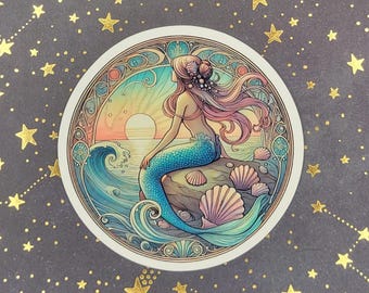 May include: A sticker featuring a mermaid with long pink hair sitting on a rock with a blue tail and a seashell crown. The background is a sunset with a wave and seashells.