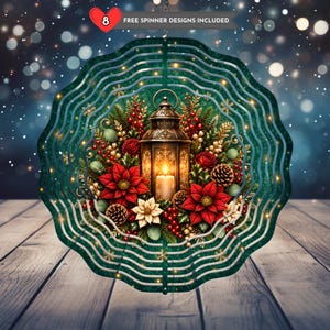 May include: A circular metal wind spinner featuring a central illustration of a lit lantern surrounded by red poinsettias, pinecones, and holly berries. The text 8 FREE SPINNER DESIGNS INCLUDED is printed at the top of the design.