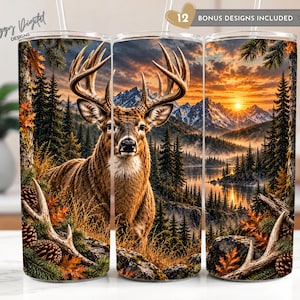 May include: A cylindrical tumbler featuring a wrap-around graphic of a deer with large antlers in a forest landscape. The scene includes pine trees, mountains, and a sunset over a lake. Text at the top reads 12 BONUS DESIGNS INCLUDED.