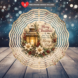 May include: A circular metal wind spinner featuring a holiday design with a glowing lantern, white poinsettias, pine cones, and red berries. The text reads Merry Christmas & May Your Days Be Merry & Bright. Includes 8 free spinner designs.