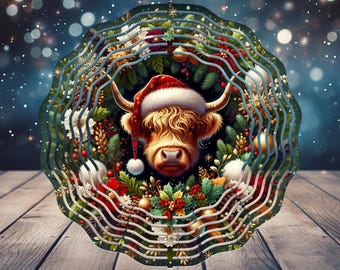 May include: A decorative Christmas ornament featuring a Highland cow wearing a Santa hat, surrounded by festive greenery and berries. The ornament has a layered design with a wavy, teal-colored frame. Text reads "FREE SPINNER DESIGNS INCLUDED".