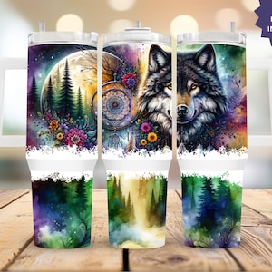 May include: Three white insulated tumblers with handles, each featuring a different watercolor design. One depicts a wolf, another a dreamcatcher, and the third a forest scene with a full moon. The text "8 FREE DESIGNS INCLUDED" is visible.