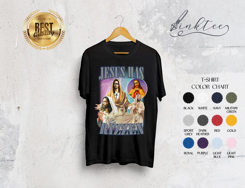 May include: Black t-shirt with a graphic design featuring images of Jesus and the text "JESUS HAS RIZZAEN" in a stylized font. The shirt includes a color chart with options like black, white, and navy.