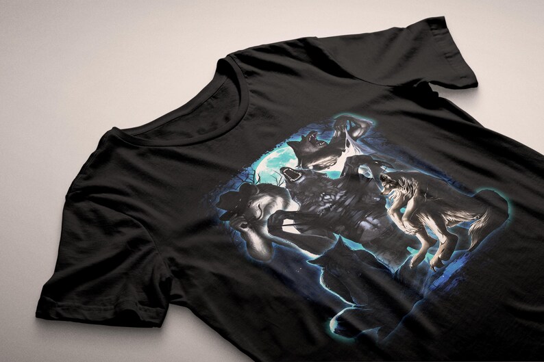 May include: Black t-shirt with a graphic of wolves howling at the moon. The design features a full moon and a blue and white colour scheme. The shirt is made of a soft material.