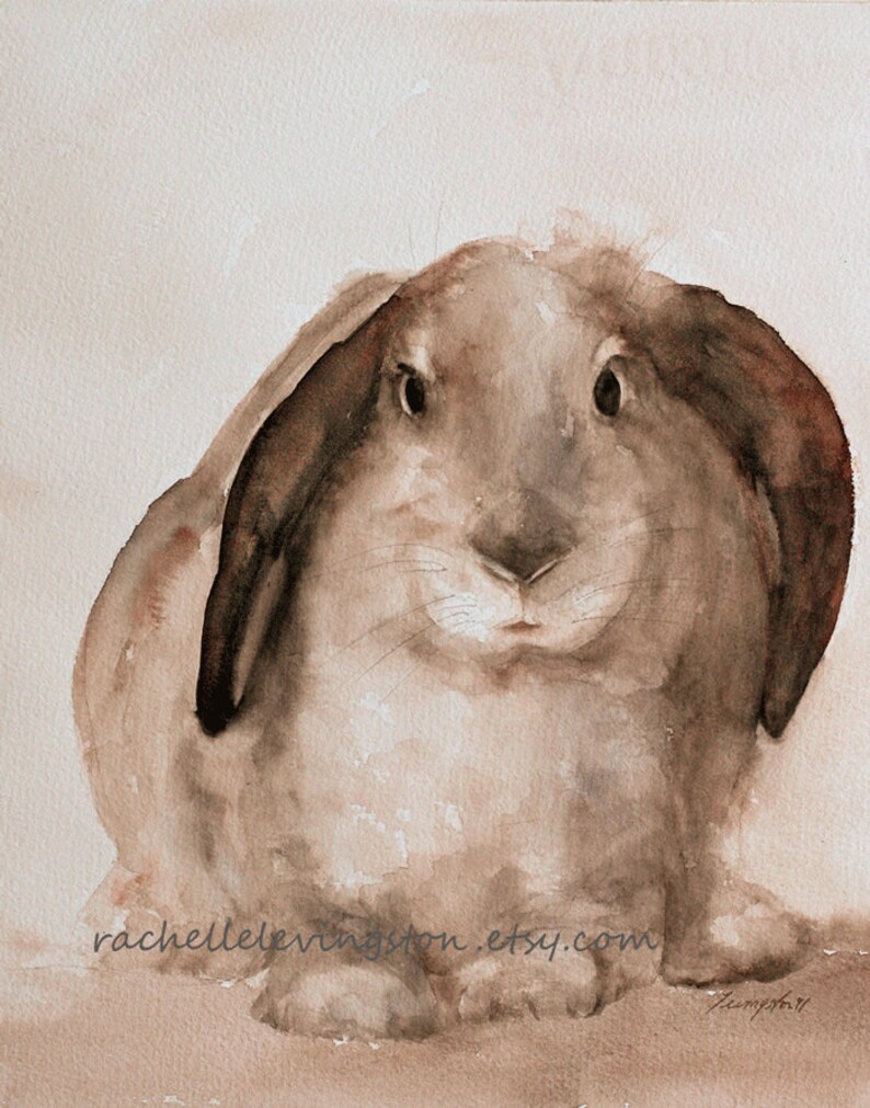 May include: Watercolour painting of a brown rabbit with large floppy ears. The rabbit is looking directly at the viewer with a curious expression. The painting is done in shades of brown and beige.