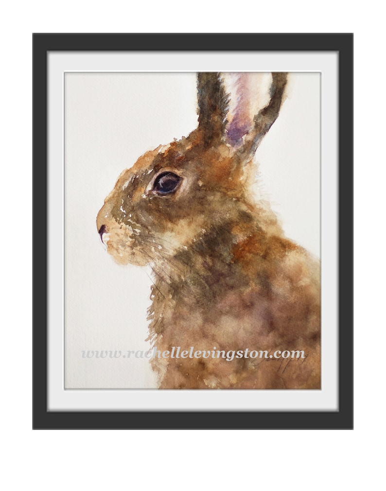 May include: Watercolor painting of a brown rabbit with a white background. The rabbit's fur is painted with shades of brown, and its eyes are dark. The rabbit's ears are long and pointed.