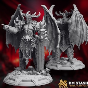 May include: Two gray demon figurines with large wings, horns, and armor. One figure holds a sword and points with its other hand. The other figure stands behind it. The figurines are on circular bases. The DM STASH logo is in the bottom right corner.