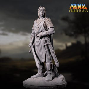 May include: A gray figurine of a medieval knight, standing with a sword in hand and another sheathed at his side. The knight is wearing armor, a cape, and boots. The figurine is on a small, textured base. The logo "PRIMAL COLLECTIBLES" is in the upper right corner.