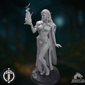 May include: A grey 3D-printed figurine of a female elf holding a flame. The elf is wearing a flowing gown and cape, with intricate details. The figurine is mounted on a decorative base. The base has a diameter of approximately 5 cm.