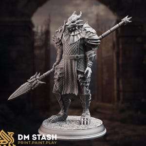 Puede incluir: Una detallada figura plateada de un guerrero dragón, completa con armadura, una lanza y una cabeza de dragón. La figura se alza sobre una base circular, mostrando intrincados detalles y texturas. La imagen incluye el texto "DM STASH PRINT.PAINT.PLAY."
