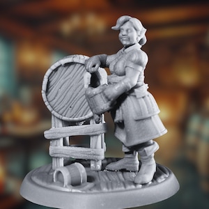 Puede incluir: Una figura miniatura gris de una mujer con un vestido y un delantal, sosteniendo un cubo y de pie junto a un barril de madera sobre un soporte.