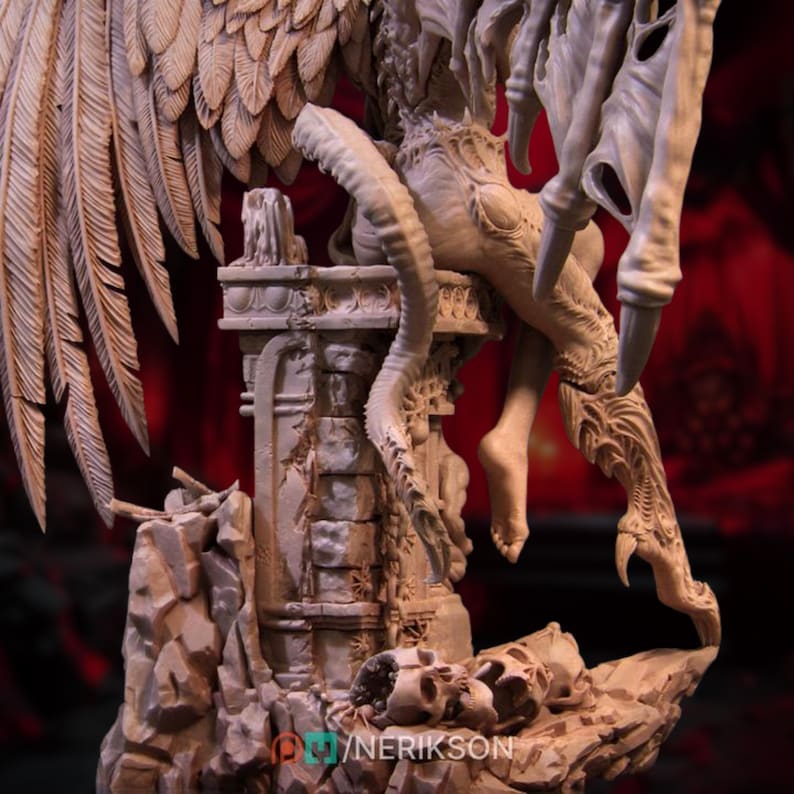 May include: A detailed, beige-colored fantasy sculpture featuring a winged creature perched atop a crumbling stone structure. The sculpture includes intricate details of feathers, claws, and skeletal elements. The base of the sculpture has the text "@YNERIKSON".