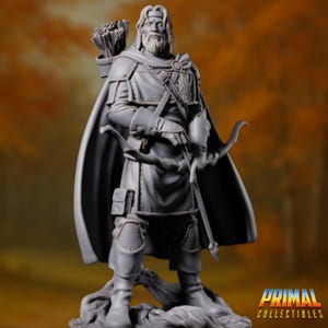 May include: A grey painted figurine of a man with a long beard and a bow and arrow. He is wearing a long cloak and a tunic. The figurine is standing on a base with a tree stump.