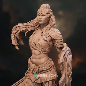 Close-up of the miniature's face and upper body. Her expression is stoic and powerful, and intricate patterns decorate her chestplate and headband.