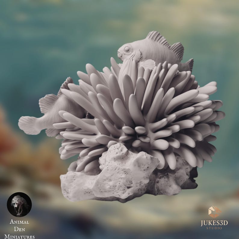 Front-facing angle of the coral reef miniature with two clownfish visible among the coral. The fish appear to move naturally through the structure, with fins slightly extended. The sculpt captures a lively reef environment with strong detail for painting and display.