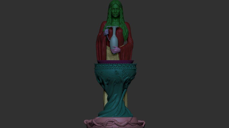 Colour-coded digital 3D model render showing the separate printable parts of the elven priestess miniature. The figure body is shown in green, outer robe in red, skirt section in yellow, ewer in light teal, hands in purple, pedestal bowl and stem in dark teal, and base in pink. Dark grey background.
