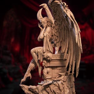 May include: A detailed sculpture of a winged figure with horns, seated on a stone pedestal. The figure is draped in flowing garments, with one hand covering its face. The sculpture has large, feathered wings and is set against a dark background.
