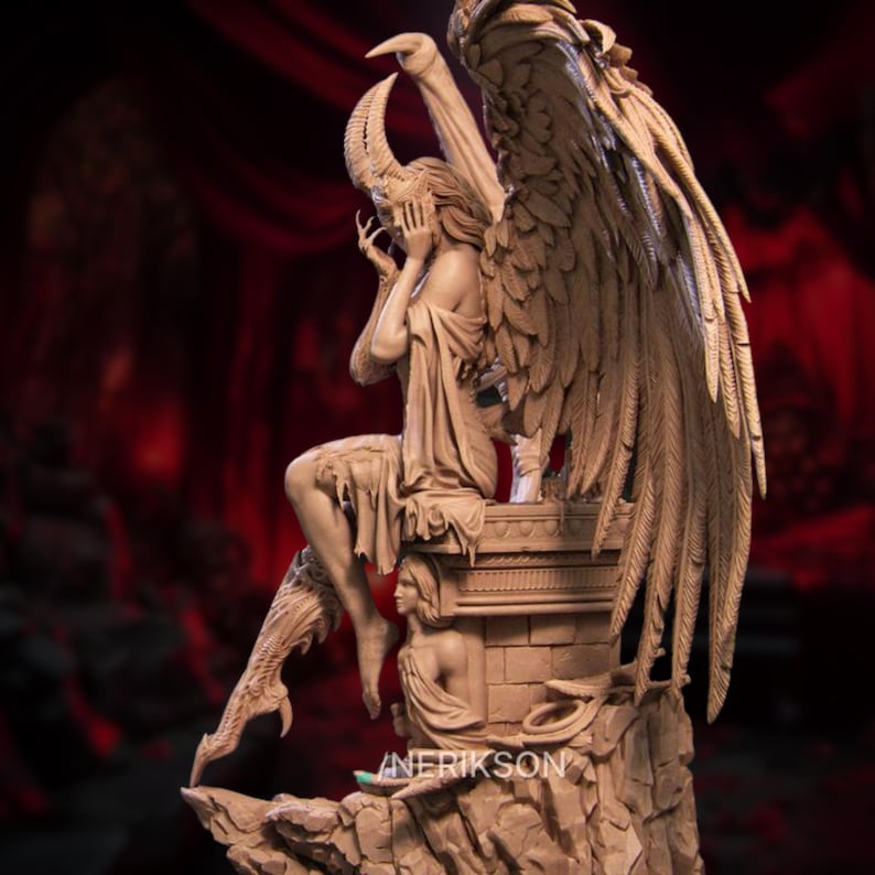 May include: A detailed sculpture of a winged figure with horns, seated on a stone pedestal. The figure is draped in flowing garments, with one hand covering its face. The sculpture has large, feathered wings and is set against a dark background.