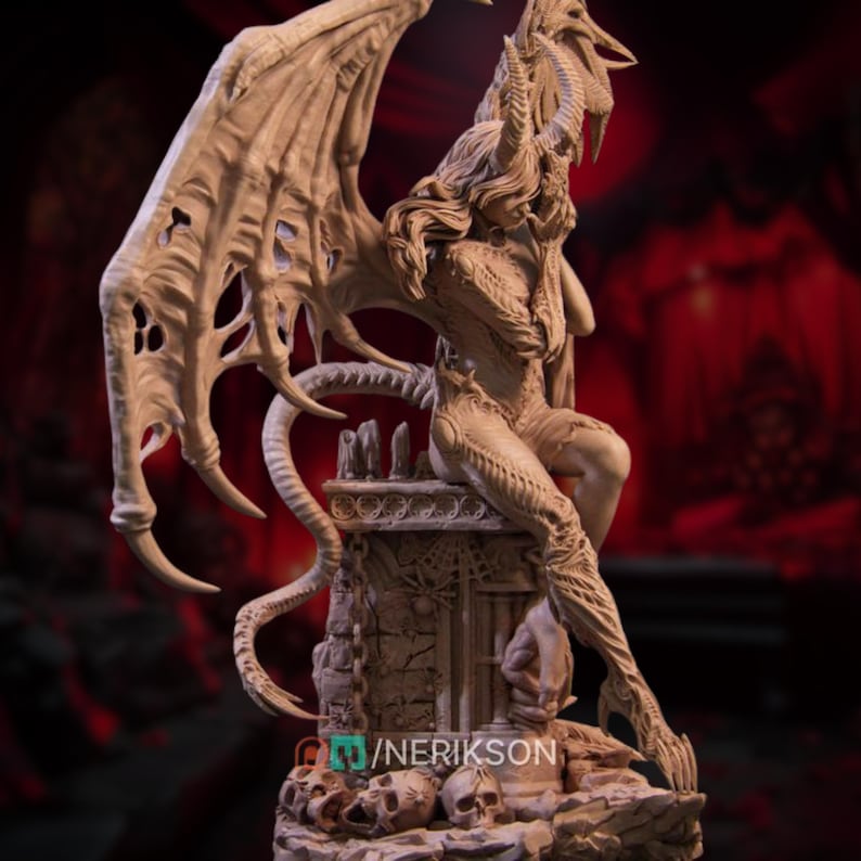 May include: A detailed sculpture of a seated demonic figure with large, textured wings and horns. The figure is posed atop a stone structure, with intricate detailing on the body and wings. The sculpture has a neutral color palette.