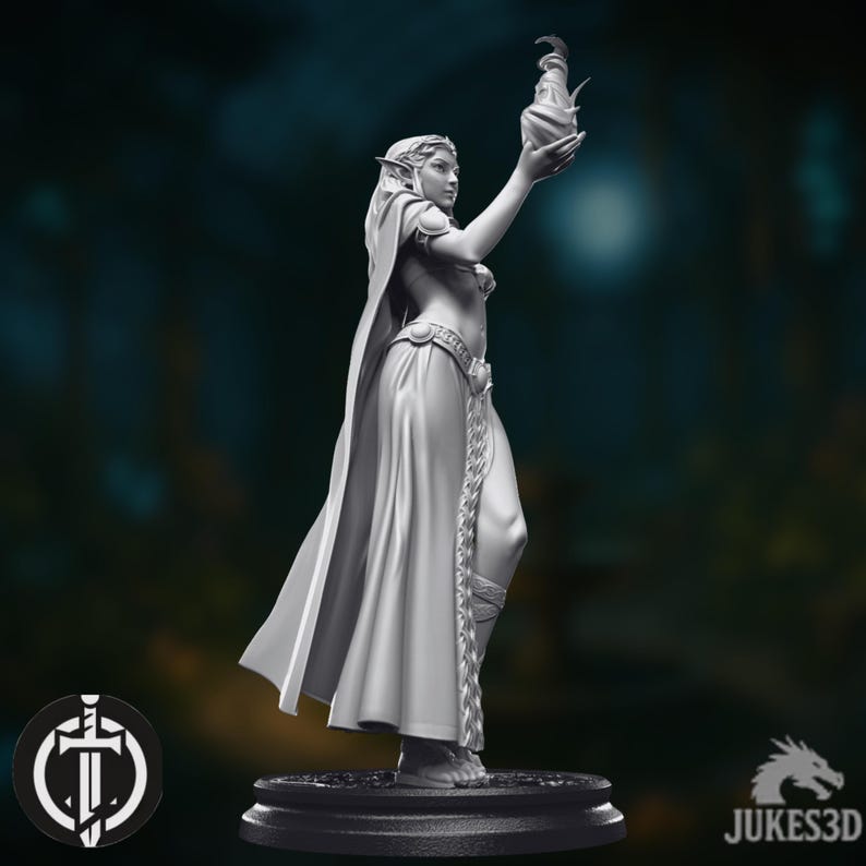 May include: A grayscale figurine of a female elf holding a decorative vessel aloft. The elf is wearing a flowing gown, cape, and ornate belt. The figurine is on a round base, with the JUKES3D logo visible.