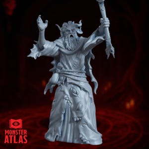 May include: A light gray figurine of a fantasy wizard with a long beard, horns, and a staff. The wizard is wearing a long robe with a detailed design. The figurine has the "Monster Atlas" logo on the bottom left.