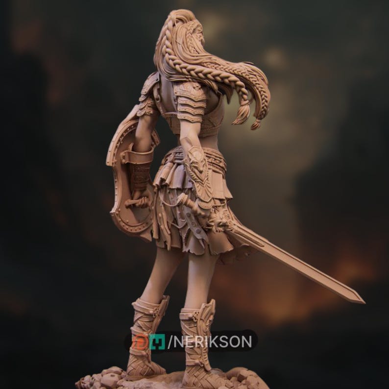 Rear view of the 32mm warrior, showcasing her layered skirt, long braid, and the base detail including a broken skeleton and sword.