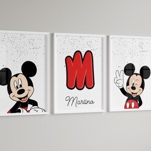 May include: Set of three framed prints featuring Mickey Mouse. One print shows Mickey peeking over a red and white border, another displays a red letter "M" with the name "Martina", and the third has Mickey giving a peace sign.