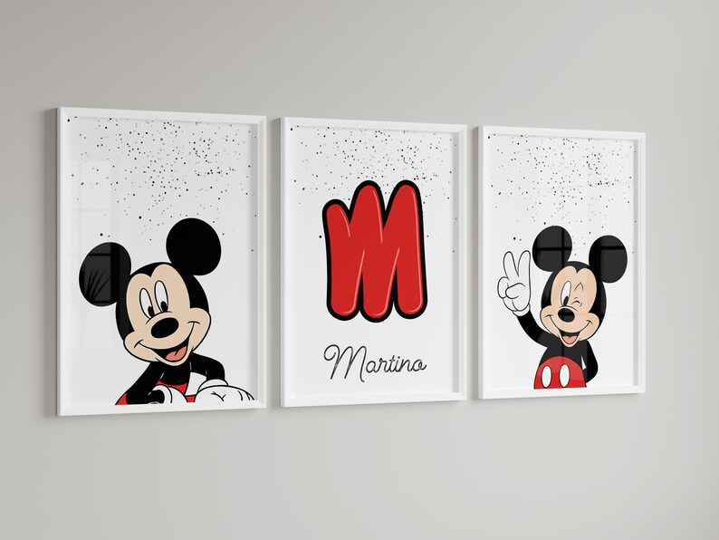 May include: Set of three framed prints featuring Mickey Mouse. One print shows Mickey peeking over a red and white border, another displays a red letter "M" with the name "Martina", and the third has Mickey giving a peace sign.