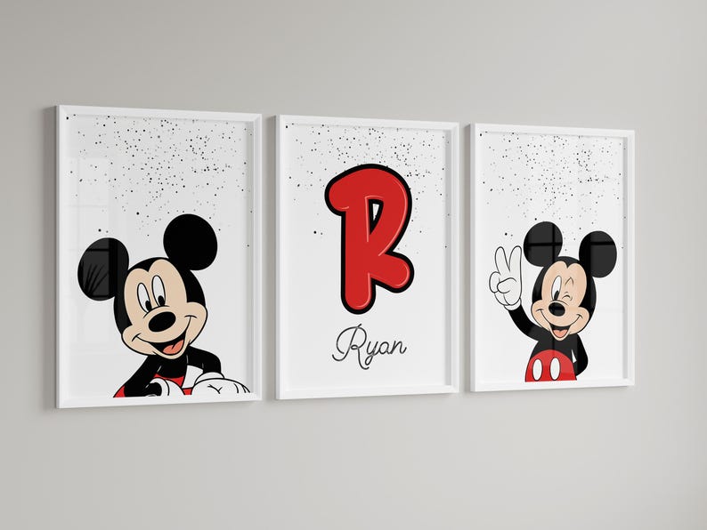 May include: Three framed prints featuring Mickey Mouse. One shows Mickey peeking over a surface, another displays a red letter "R" with the name "Ryan", and the third has Mickey giving a peace sign. All are set against a white background with black speckles.