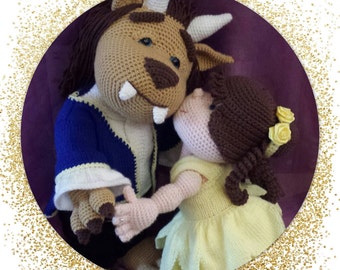 May include: A crocheted plush toy of the Beast from Beauty and the Beast, in a blue jacket, holding a crocheted plush toy of Belle, wearing a yellow dress.