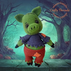 May include: A green crocheted zombie pig with purple and red clothing. The pig is standing on a wooden surface with a background of a spooky forest.