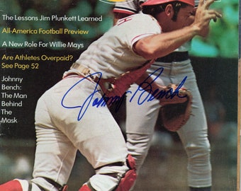 May include: A vintage magazine cover featuring a baseball player in a red and white uniform, catching a ball. The magazine cover is titled "Sport" and features the text "The Lessons Jim Plunkett Learned" and "All-America Football Preview".