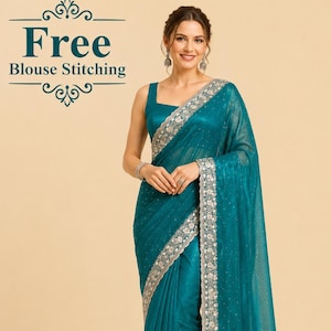 May include: A teal saree with a square neckline and silver embroidered trim. The saree features a sheer overlay and is draped over a matching teal blouse. The image includes the text "Free Blouse Stitching".