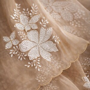 May include: A white ceramic mug with a black handle and the text "But First, Coffee" in a black, handwritten-style font. The mug is on a white surface.