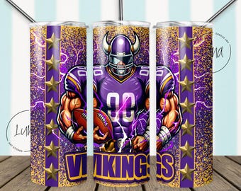 May include: A purple and gold tumbler featuring a muscular football player in a Vikings uniform, holding a football. The design includes gold stars, lightning bolts, and the word "VIKINGS" in bold letters. The tumbler has a straw.