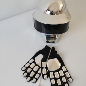 May include: A silver robot costume helmet with a black visor, a pair of silver and black gloves, and a silver triangle pendant necklace.