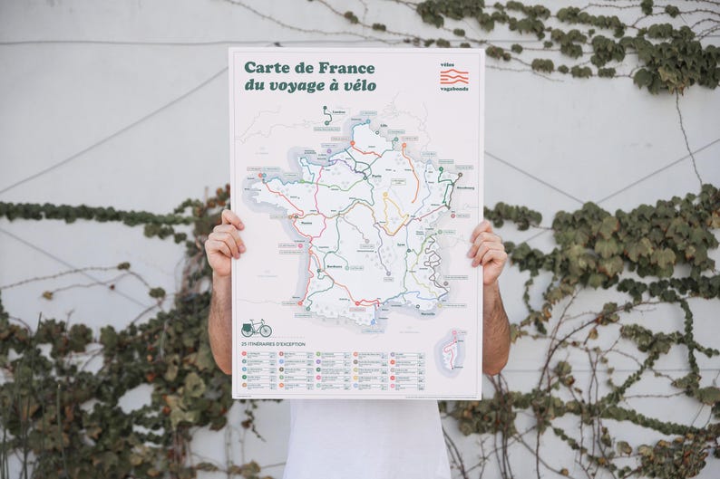 May include: A white poster with a map of France showing cycling routes. The poster has the title "Carte de France du voyage &agrave; v&eacute;lo" and a list of cycling routes.