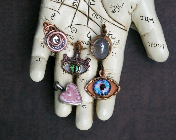 Unusual Luck Charm, choose Silver Heart, Brass Eye, Bronze Moonstone, Copper Eye or Crescent