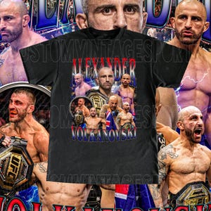 May include: Black t-shirt with a graphic print of a mixed martial arts fighter, Alexander Volkanovski, with the text "Alexander Volkanovski" printed on the front. The graphic features Volkanovski in a fighting pose with other fighters in the background.