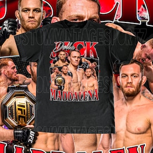 May include: Black t-shirt featuring a collage of UFC fighter Jack Della Maddalena. The shirt has a vintage design with the fighter's name in red and white lettering. The background includes images of other UFC fighters.
