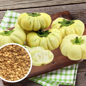 May include: A collection of pale yellow, turban-shaped squash with green stems, displayed on a wooden cutting board atop a green and white checkered cloth. A circular inset shows numerous seeds. The squash has a ribbed texture and a light green hue.