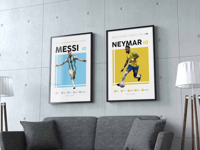 May include: Two framed posters of soccer players, Lionel Messi and Neymar Jr., with their jersey numbers, 10, and the text "MESSI" and "NEYMAR" in black on a white background. The posters are on a gray wall with a gray couch in front of them.